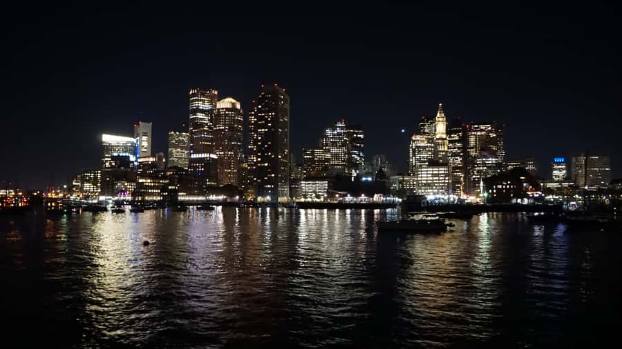 Boston: City Lights Sightseeing Cruise on Classic Boat - Downtown buildings light up across the harbor